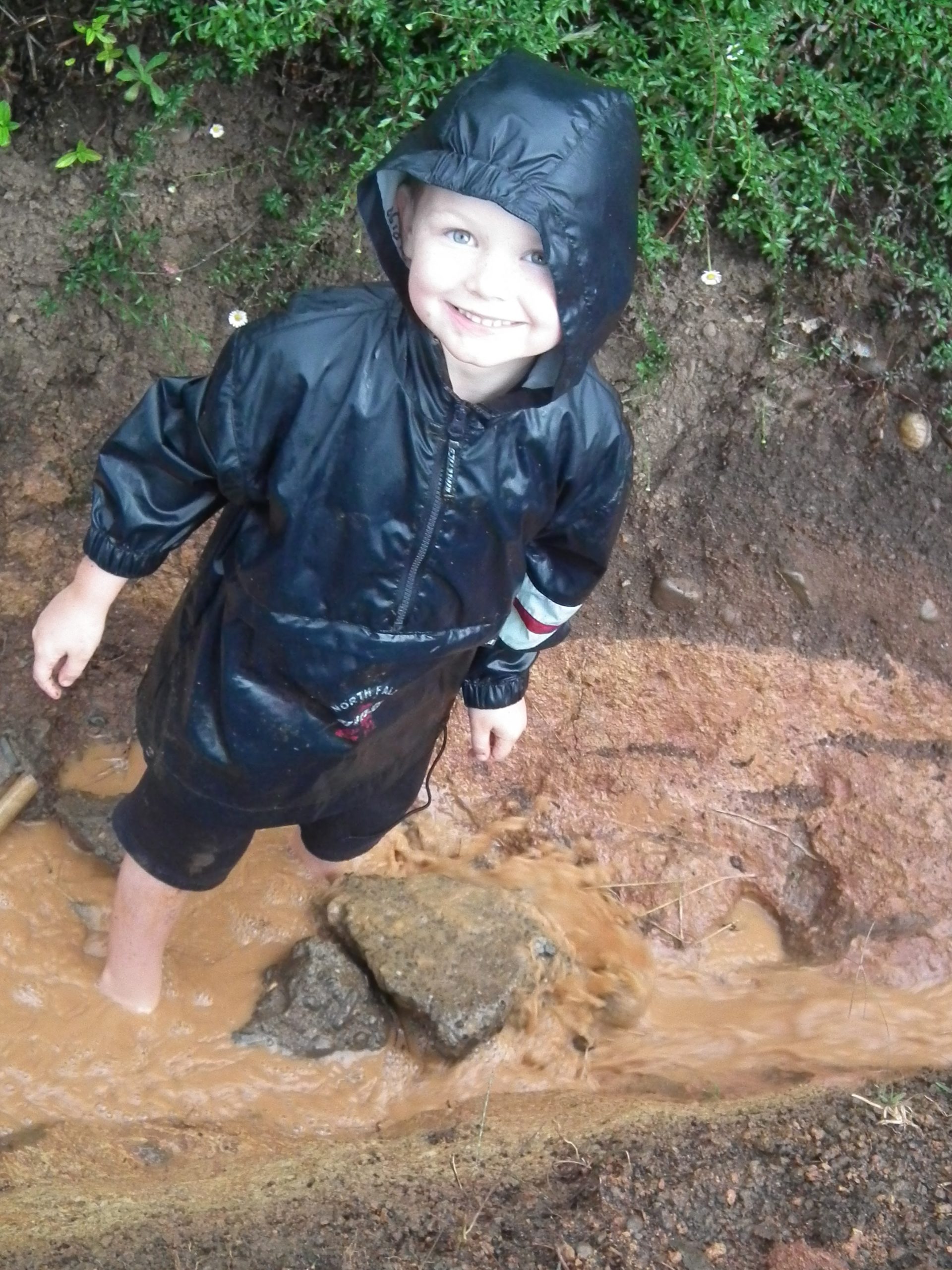Joshua plays in the mud