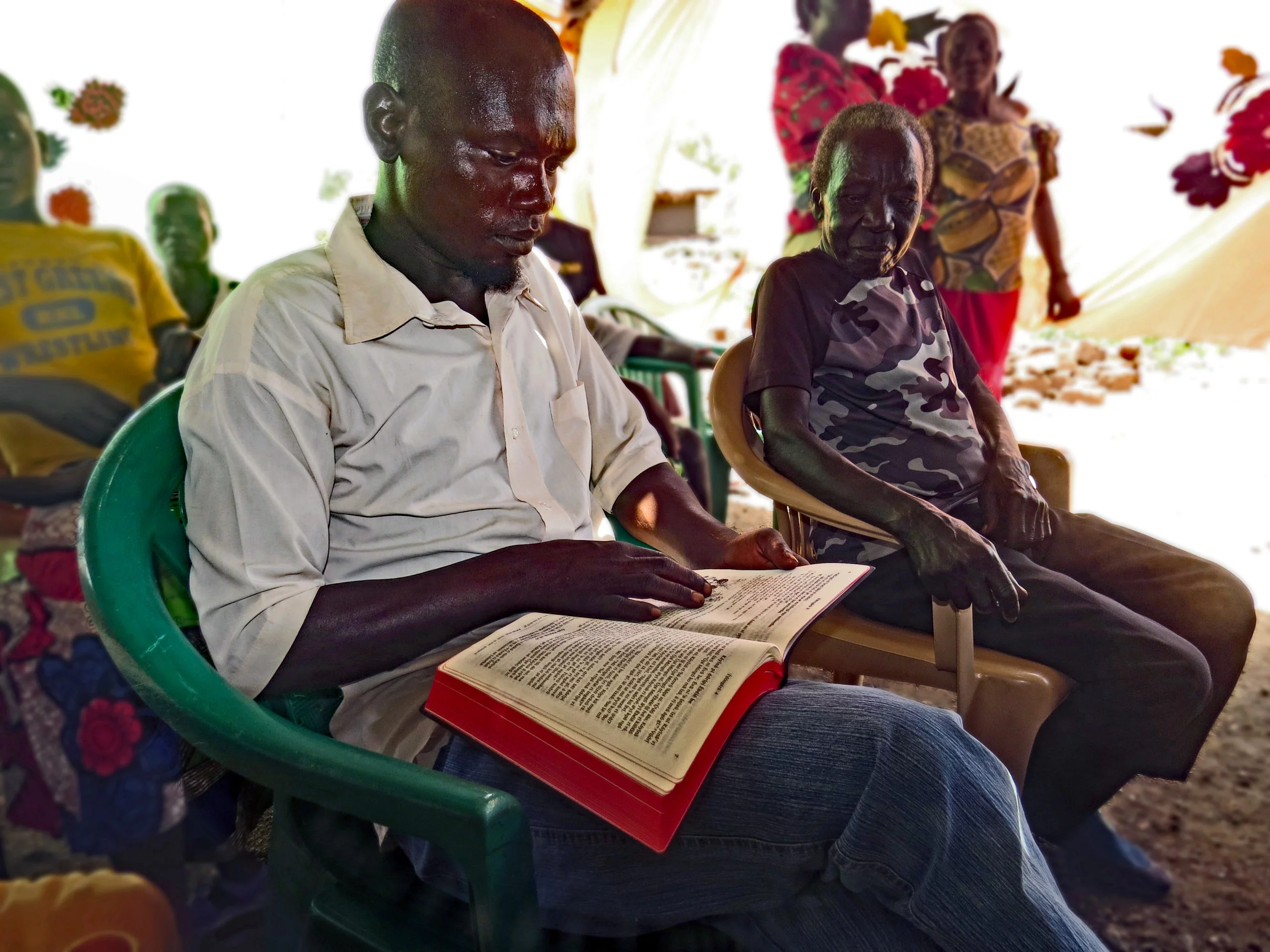 A Keliko man reading the New Testament