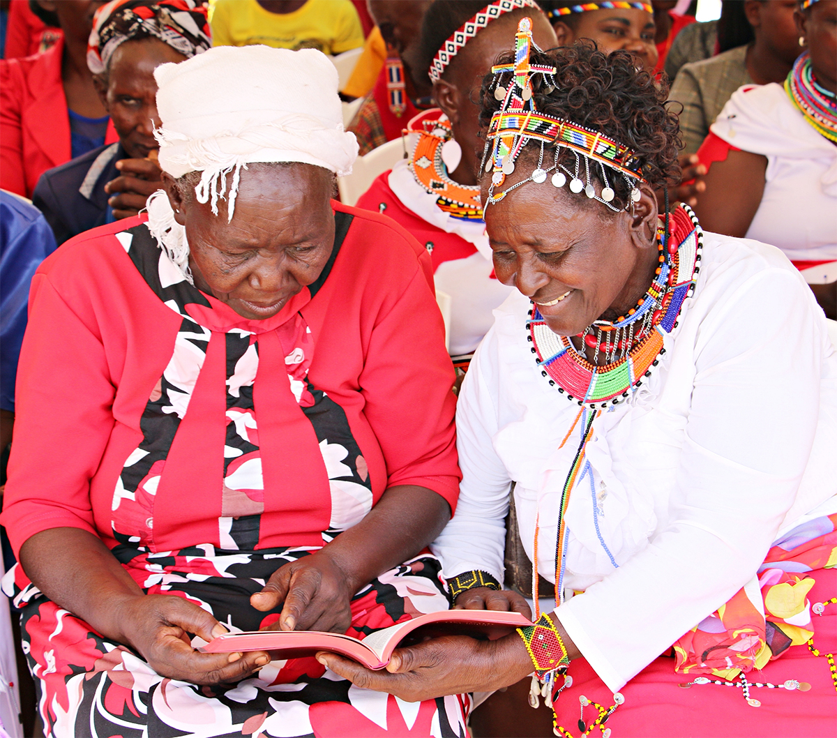 Image of elderly women reading the newly launched Ilchamus New Testament