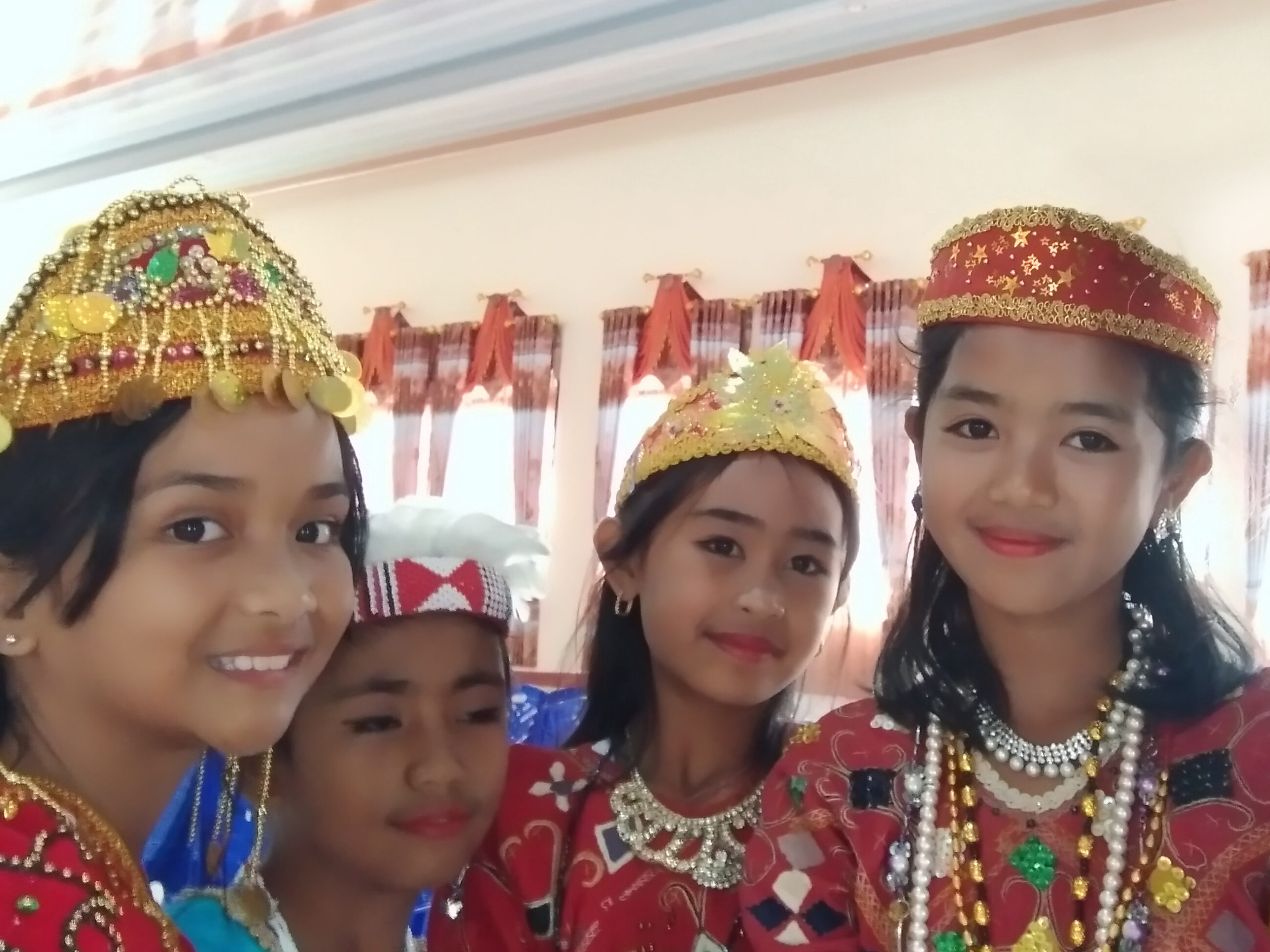 Image of four Tado girls at the Tado New Testament launch in Lindu, Indonesia
