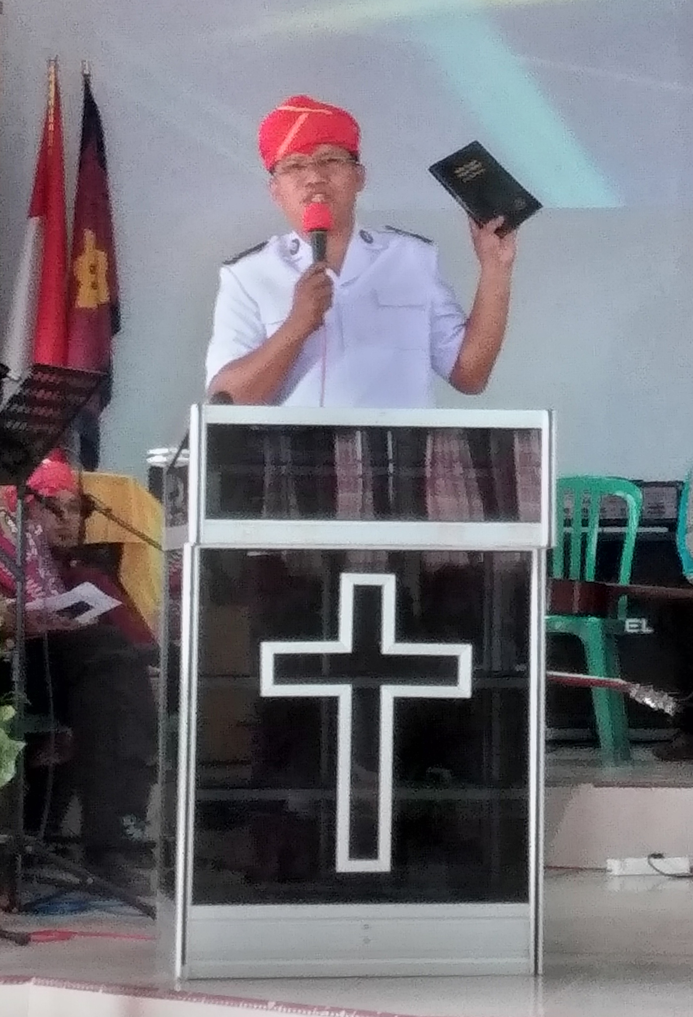Image of the Tado New Testament being held up at the launch event in Lindu, Indonesia