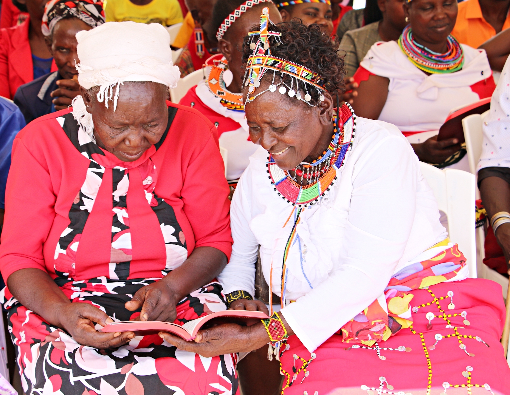 Two Ilchamus women enjoy reading the Ilchamus New Testament in Kenya for the first time.