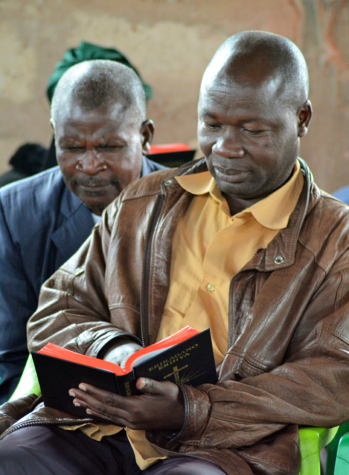 Image of a man reading his Kabwa New Testament at the launch event in Tanzania