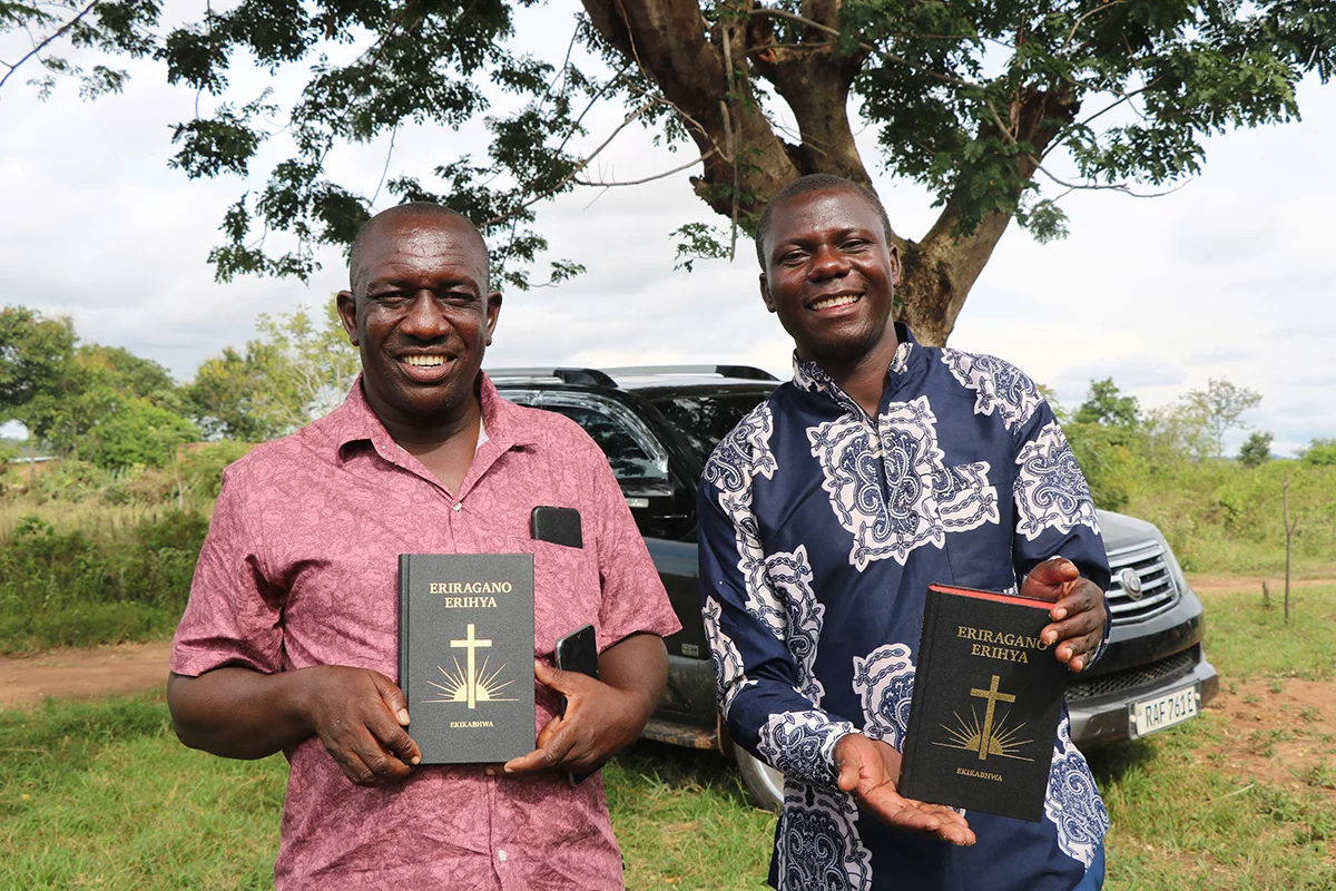 Masige and Miriro, the two Kabwa translators who worked on their New Testament from the early days until completion, with their Kabwa New Testaments