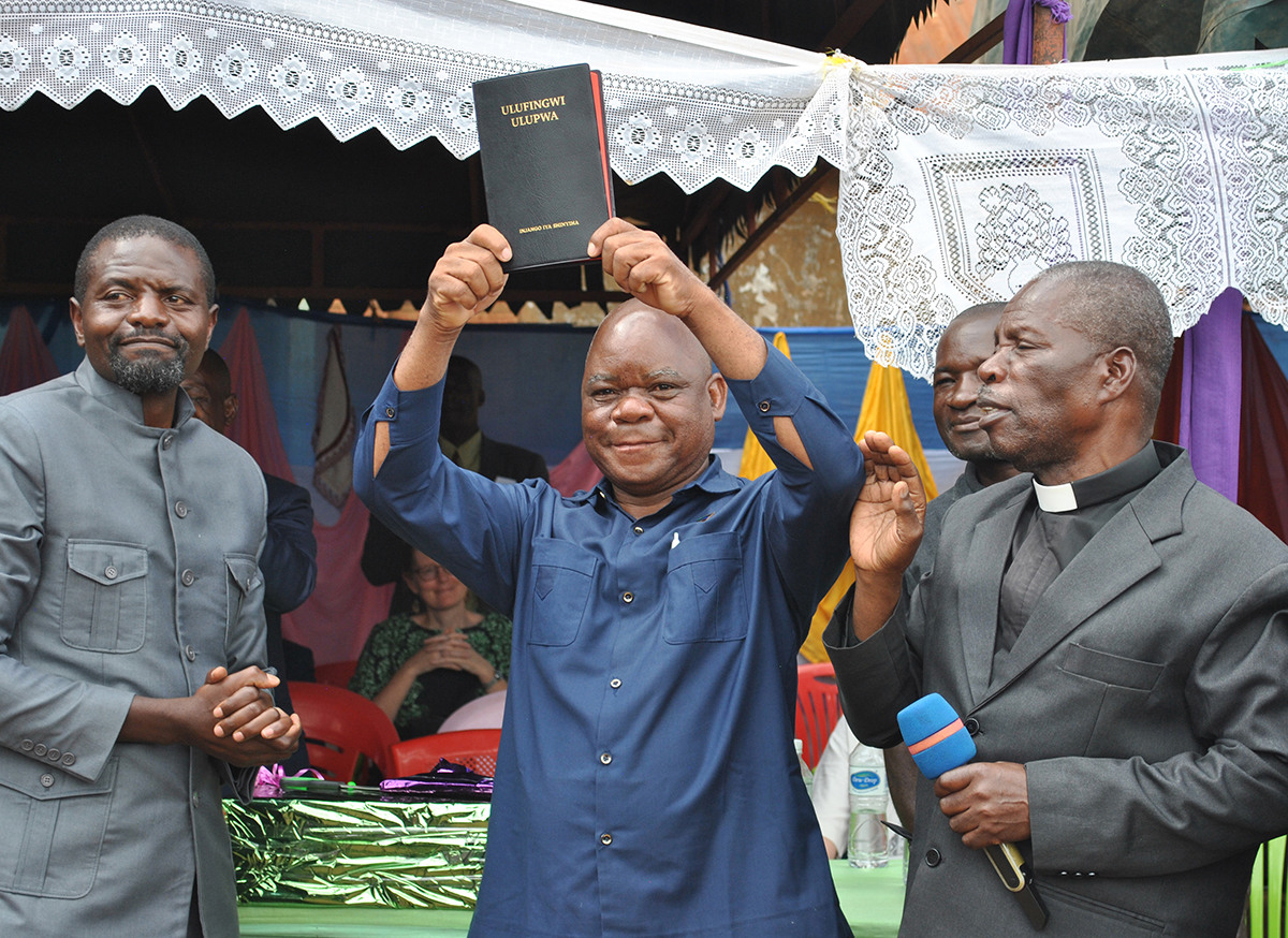 Image of the Nyiha New Testament being shown to the people