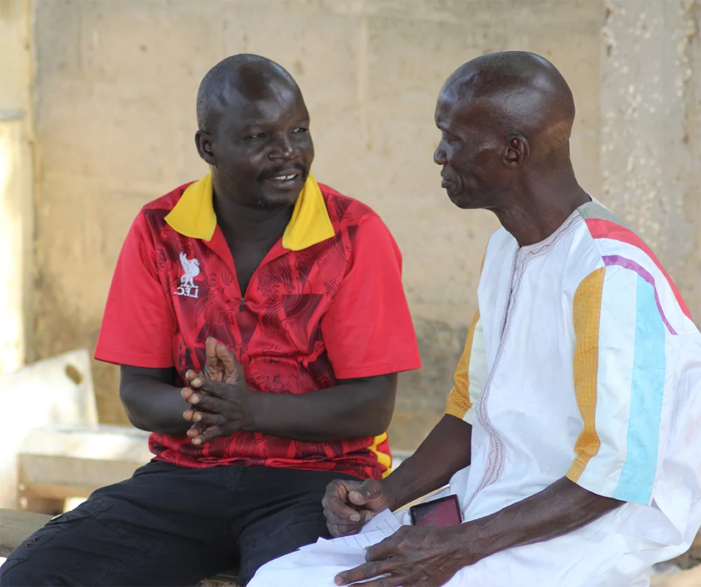 Image of two men testing the Contemporary Wolof version of the Scriptures