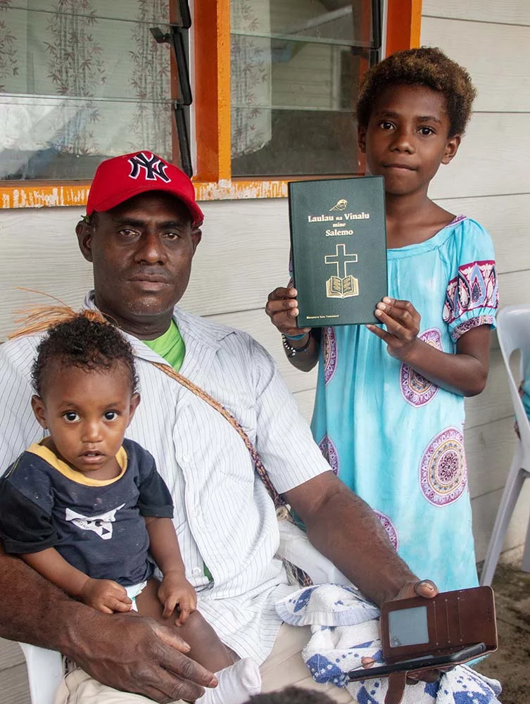 Image of a Meramera family with their newly launched New Testament