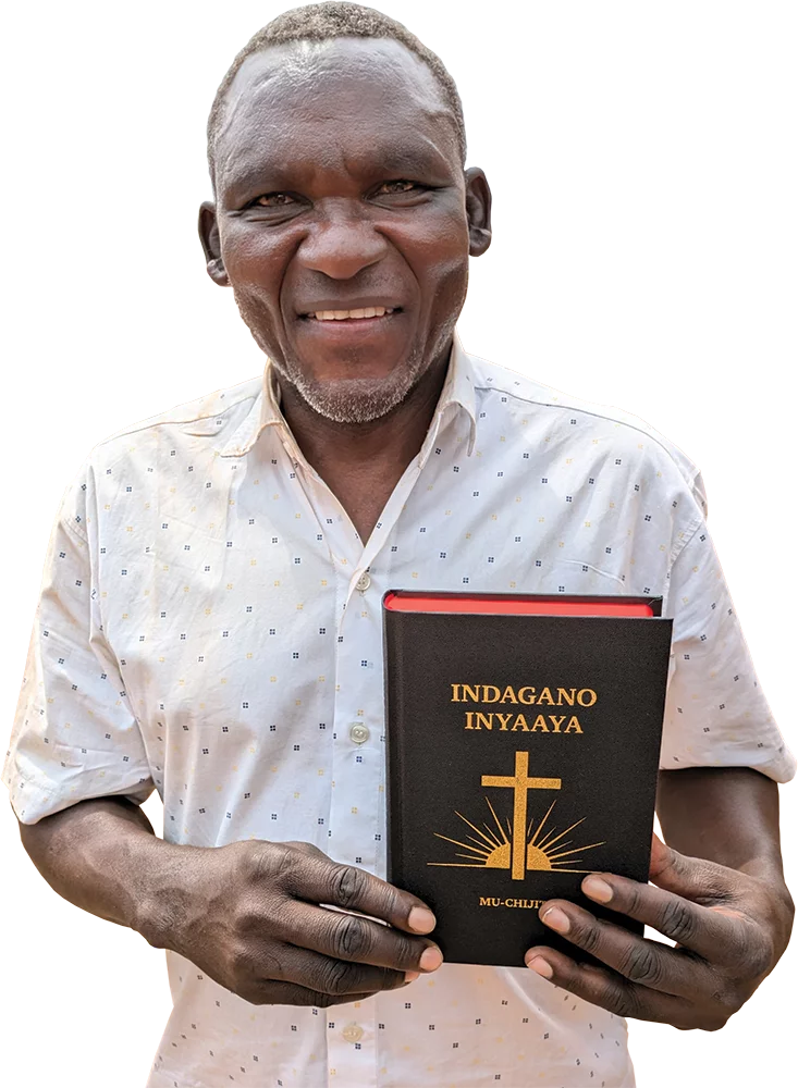 Image of a Jita man holding his newly launched Jita New Testament