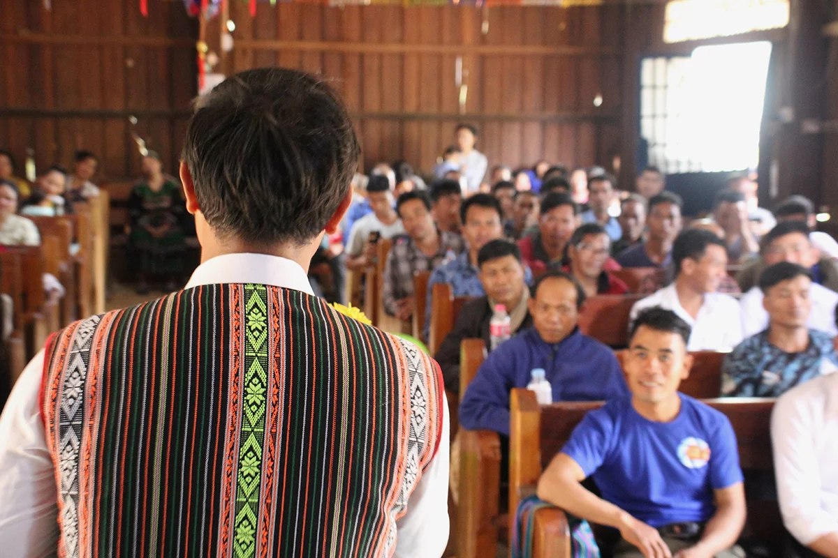 Image of Borath leading his church congregation in Cambodia