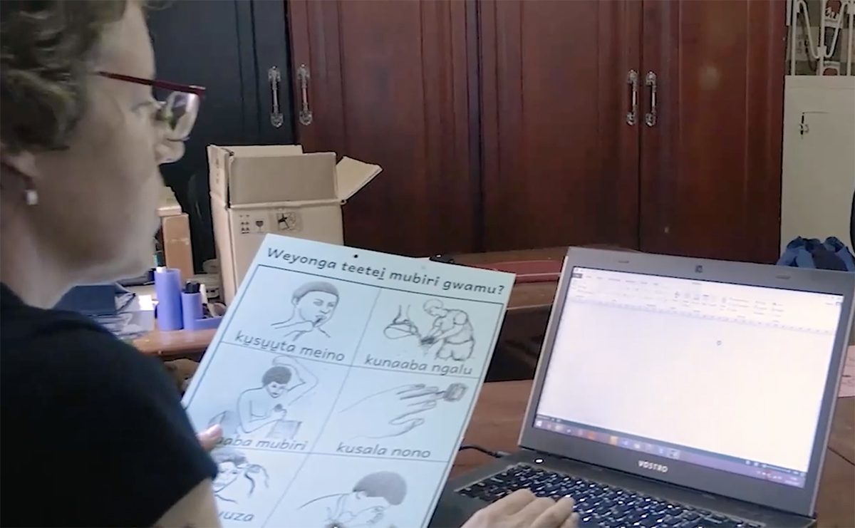Image of Kathryn Asiku working on literacy materials in Uganda