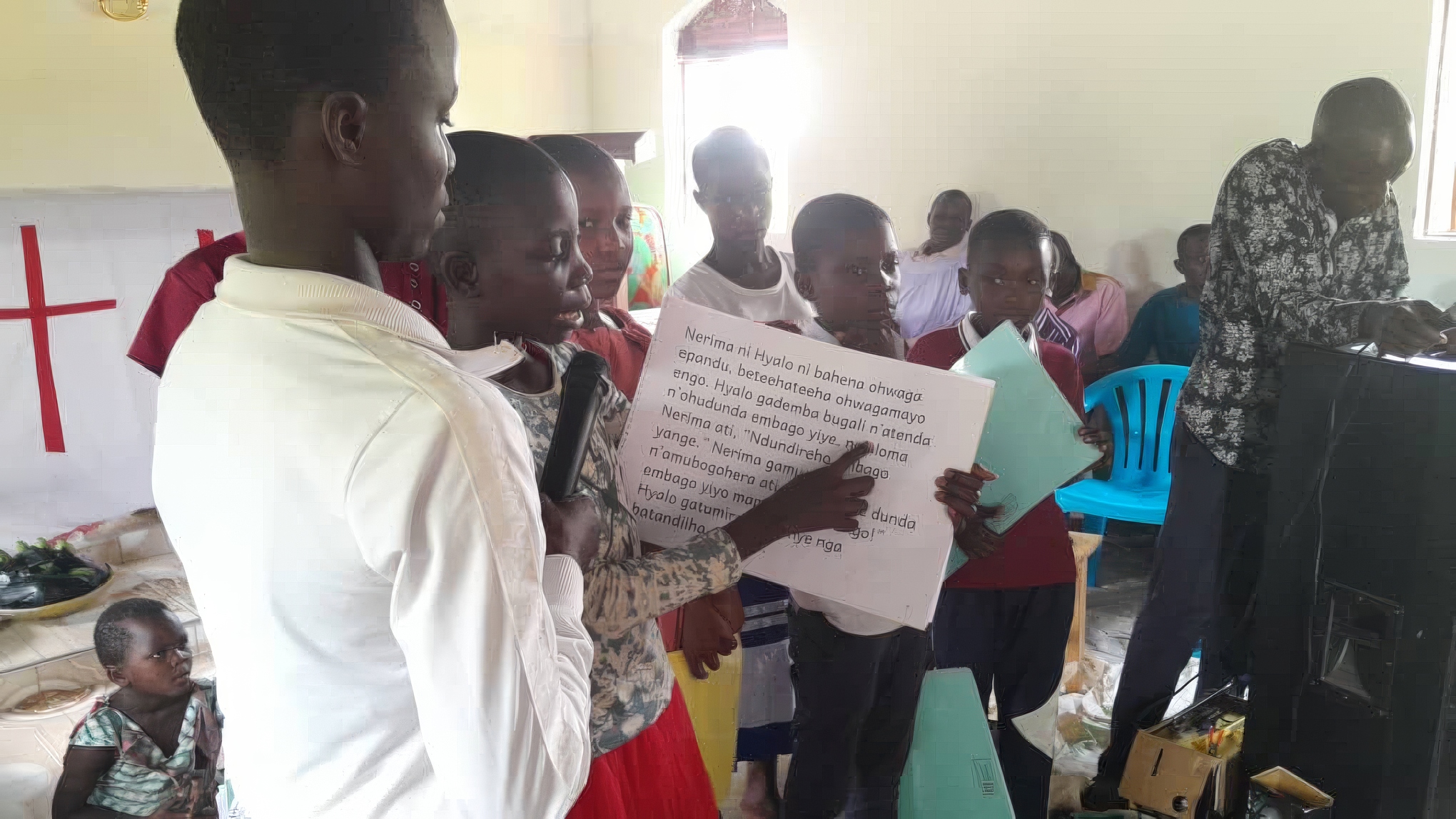 Image of children practising their reading in a ‘Let’s Read Together’ group in Uganda