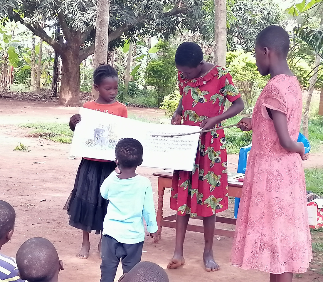 Image of a Let's Read Together group using the Big Book in Uganda